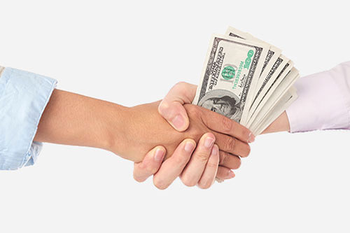 client paying money and shaking hands